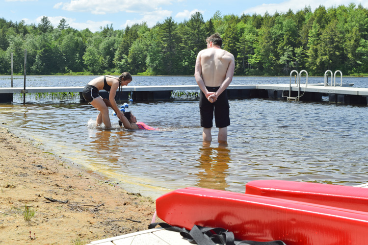 Lifeguards practicing safety and rescue techniques at the waterfront.