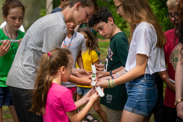 Campers must cooperate and work together to pass the marble along to the finish line without dropping it