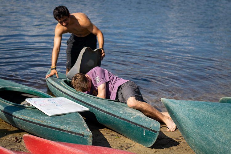 Counselor Dustin valiantly rescuing a frog from one of the kayaks