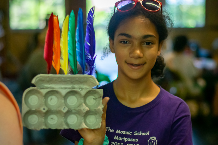 A camper showing off an art project