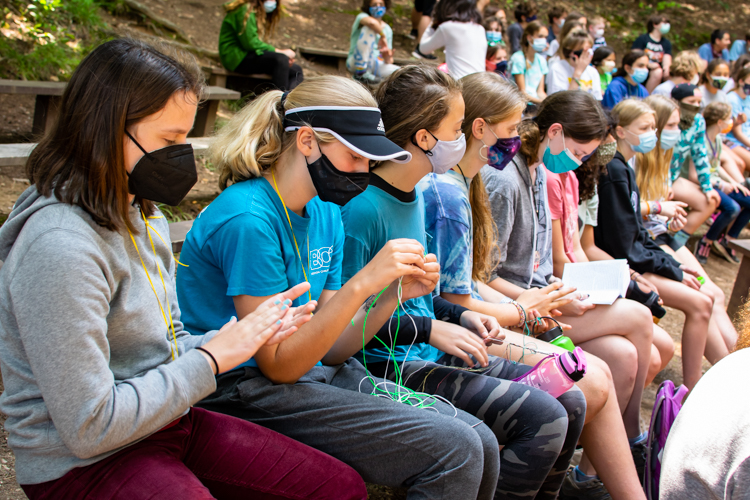 Dillard campers filling time between activities with friendship bracelets