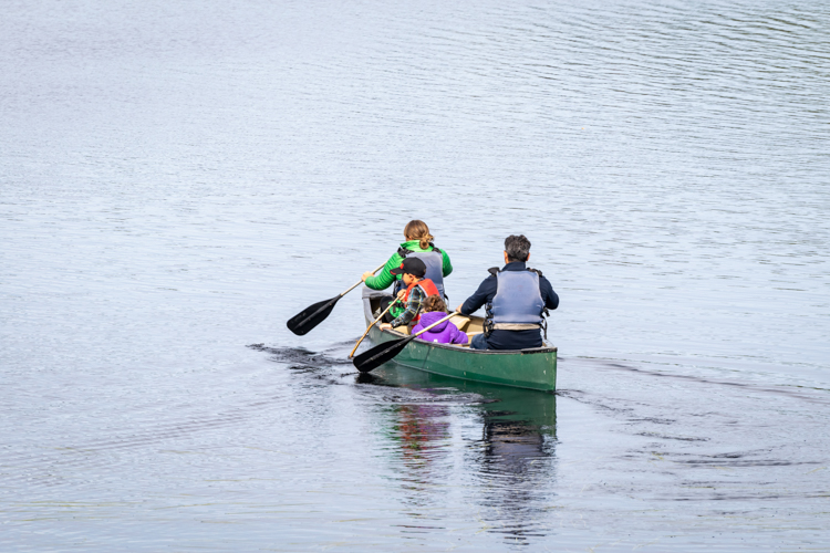 Family canoeing on Hubbard Pond