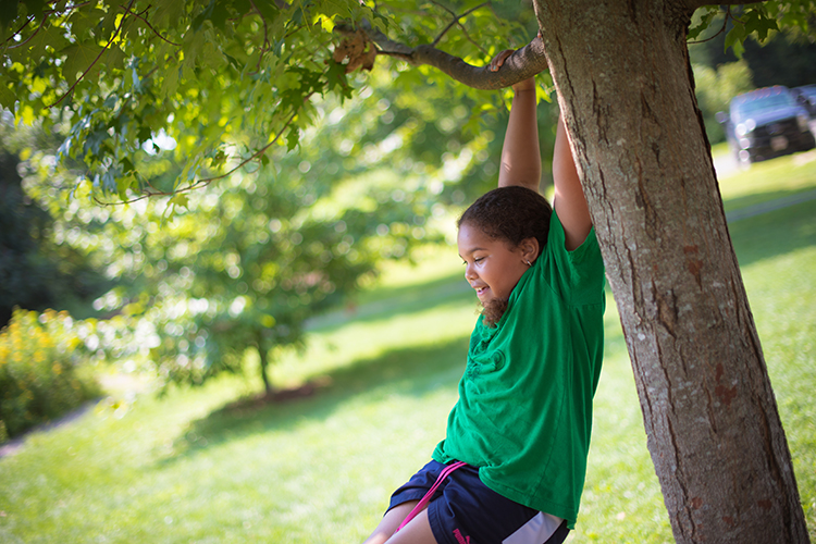 Girl playing on tree