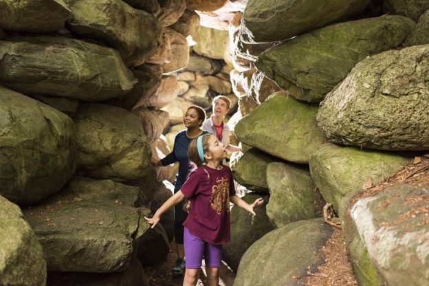 Family exploring the rock grotto at Ipswich River ©Jared Leeds