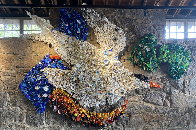 Art installation inside the Magazine Beach nature center of a bird made out of single-use plastics