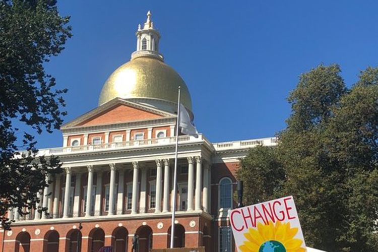 pic of the state house and a sign in front that says change